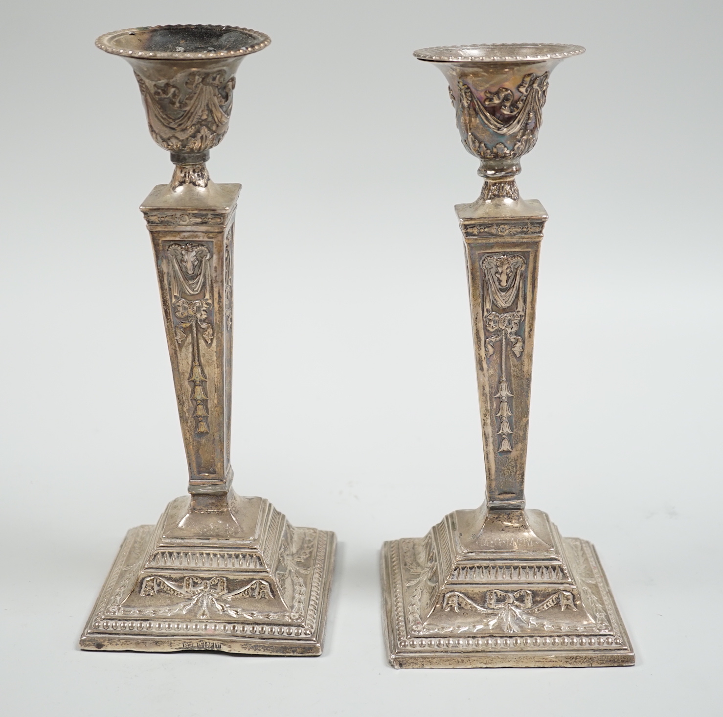 A pair of Edwardian silver mounted Adam's style candlesticks, Richard Richardson, Sheffield, 1905, height 24.8cm, weighted (solder repairs).